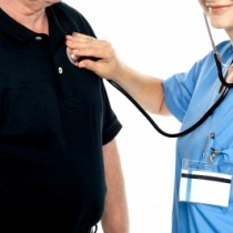 Healthcare NHS Nurse Examining male patient